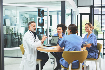 Doctor, laptop and discussion with nurse in office for healthcare research, feedback and...