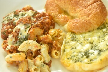 baking crispy butter croissant French bread butter garlic with macaroni dressing fried chop pork and slice tomato in ketchup sauce on plate  