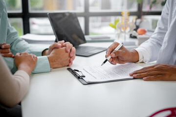 Doctor explaining medical treatment to patient holding hands