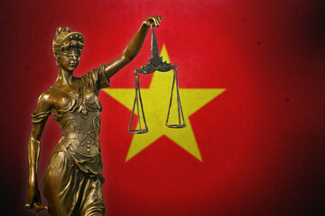 Lady Justice before a flag of Vietnam