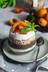 Granola with yogurt, chia and apricots in a glass
