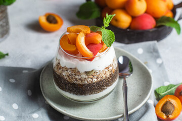 Granola with yogurt, chia and apricots in a glass
