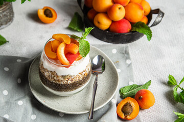 Granola with yogurt, chia and apricots in a glass
