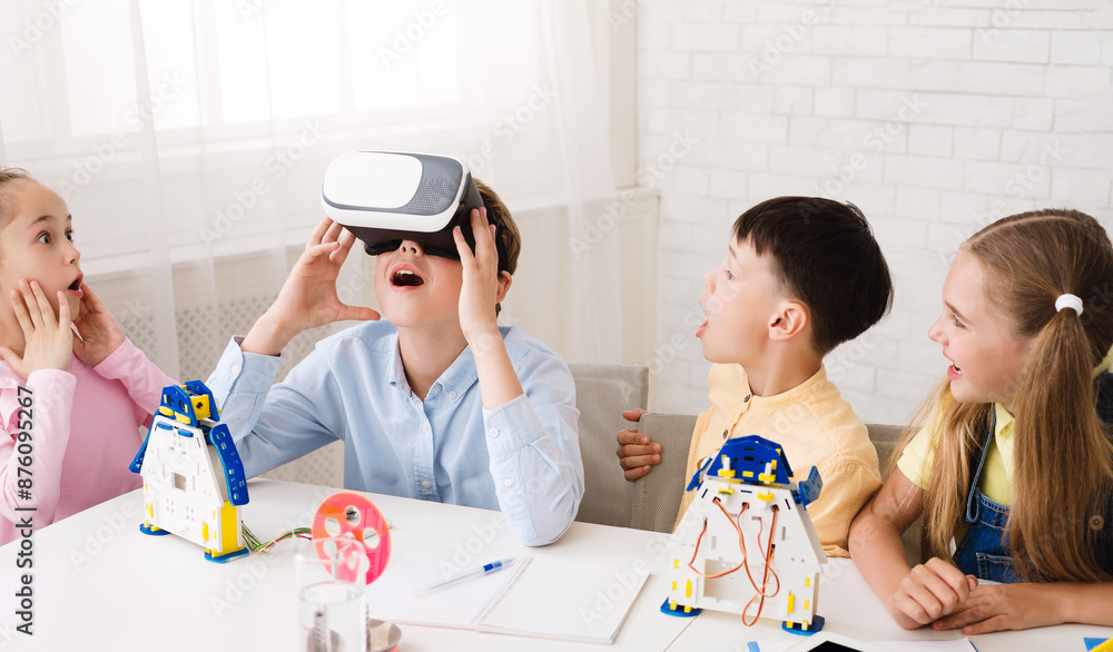 Aufkleber A group of children are engaged in a STEM learning activity, building robots and exploring virtual reality. One child wears a VR headset and looks amazed at the experience