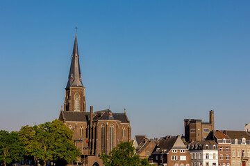 Summer cityscape of architecture traditional houses and church in Wyck district, The Sint Martinuskerk or Sint-Maartenskerk is a neo-Gothic church in the Dutch city of Maastricht, Limburg, Netherlands