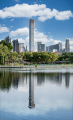 China Beijing CBD core building complex blue sky white clouds lake reflection