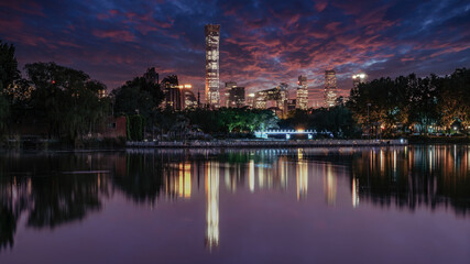 China Beijing sunset evening glow city lights lake reflection