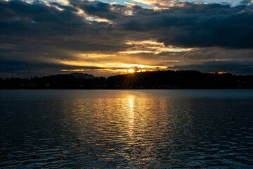 Fototapeta premium sunset, Lech river, Bavaria, Lechstausee, Schongau, Lechbruck, water, reflection, sky, clouds, silhouette, nature, landscape, evening, twilight, orange, golden, serene, peaceful, scenic, horizon, dusk