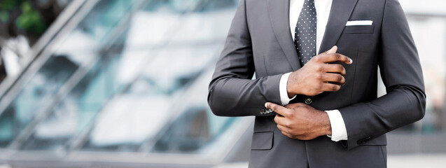 Business Life. Unrecognizable African American Man Adjusting Sleeve Cuff In City. Cropped, Free Space