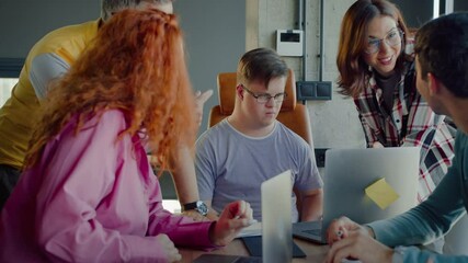 Man with intellectual disability sitting by table with pc