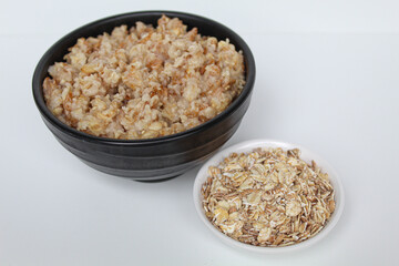 Comparison of rolled oat, before and after cooking. Isolated on white background