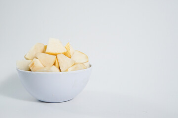 Sliced ​​pears in a bowl isolated on a white background