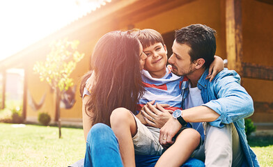 Fototapeta premium Mom, dad and boy happy in backyard with lens flare for bonding, love and vacation together outdoor. Family, portrait and care on grass or lawn with hug for support, relationship and relax in holiday