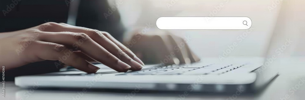 Poster closeup of a hand typing on a laptop keyboard with a search bar overlay, showing modern technology a