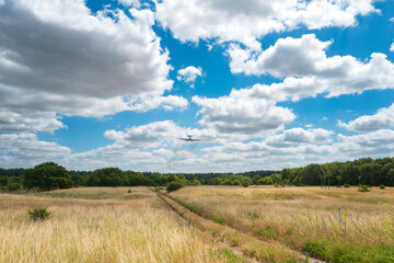 Obraz premium Distance military AWACS early warning aircraft seen on final approach to a military airbase in East Anglia, UK. The military runway is behind the photographer.