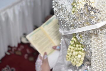 The bride is reading the wedding book photographed from behind