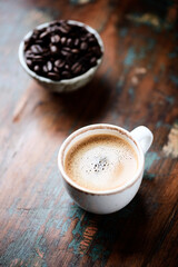 Cup of coffee on wooden background. Close up.	
