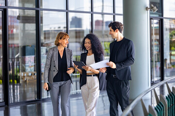 Team of diversity business people are discussing over the new strategic strategy projects on investment real estate while walking around the office building for new project and planning