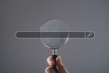 man's hand holding magnifying glass Searching for information. Using Search Console with your website. Data Search Technology Search Engine Optimization. Online business search a job for work