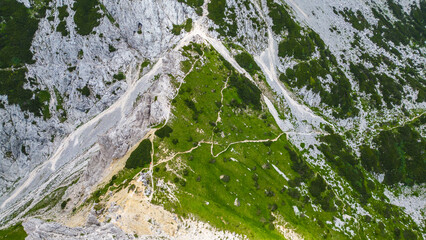 An awe-inspiring aerial view of the Slovenian Alps, featuring the majestic peaks of Viševnik,...