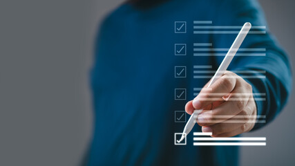 Person checking off a checklist with a marker, emphasizing task completion and organization. Modern business concept on a transparent screen.
