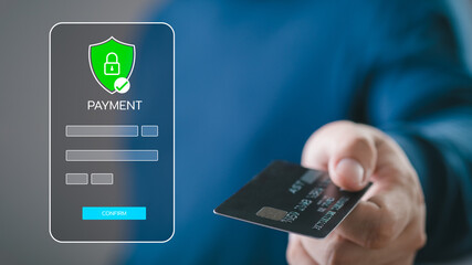 Secure online payment concept with a person holding a credit card and a digital security shield,...