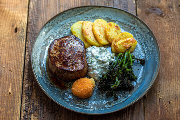 Fillet steak, potatoes, brocolini and deep fried breadcrumbed yolk