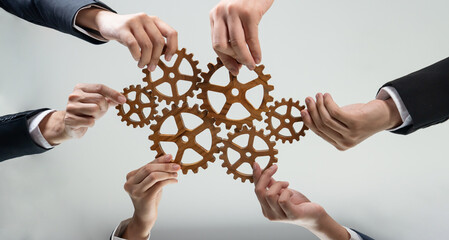 Business team joining cogwheel in circular together symbolize successful group of business...