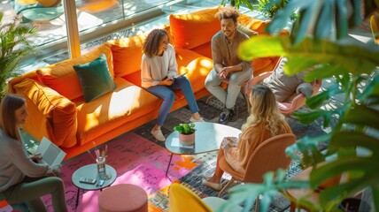 Group of diverse people in a colorful modern office with large windows and hanging lantern with vibrant color. Co-working space and collaboration concept. Aerial view photography for design. AIG53F.
