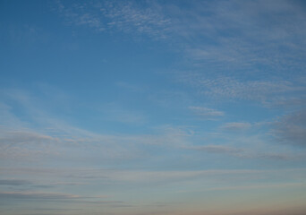 High stationary clouds and lower clouds, moving across the night sky,