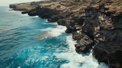 Along the rugged coast of the Atlantic Ocean, waves crash against towering cliffs, their relentless force echoing through the salty air. Seabirds soar overhead, their calls mingling with the rhythmic 