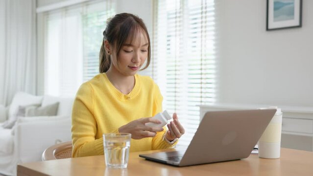 Happy fresh asia people young adult woman take skin care detox pill folic iron drinking diet zinc vit e b c d boost water for worker enjoy relax work at home desk. Herbal refresh glass immune system