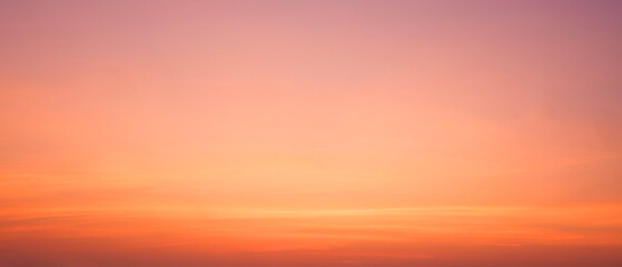Colorful orange sunset sky after sundown with yellow cloud streak on dusk sky panoramic background,...