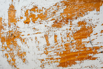 White Paint Peeling Off a Wooden Surface, Revealing The Underlying Material. The Irregular Paint...