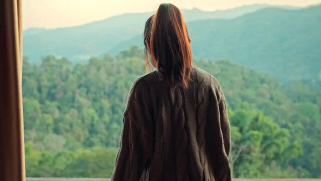 B roll - Woman opening curtains enjoy mountain view in morning, Happy traveller stay in hotel. Slow motion.