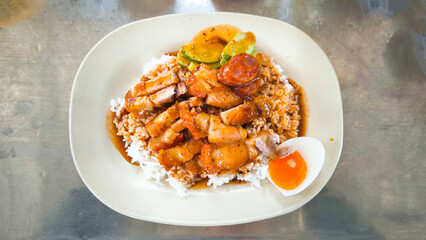 Crispy pork rice on a white plate on the dining table