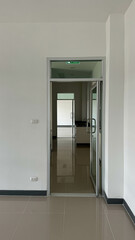 an aluminium single swinging door with fixed clear glass.