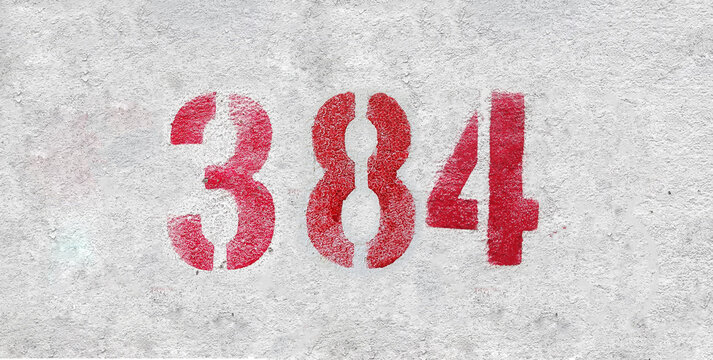 Red Number 384 on the white wall. Spray paint.