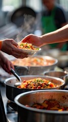 Close-up of a hand serving a plate of food at a busy kitchen station with steam rising from pots filled with delicious meals, vibrant colors, and fresh ingredients.