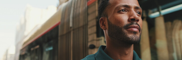 Obraz premium Close-up of young man walking in front of passing bus in the background