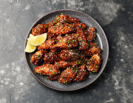 Spicy korean chicken wings with sesame seeds and chives