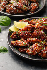 Spicy korean chicken wings with sesame seeds and chives