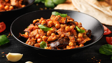 Eggplant and Chickpea Stew in tomato sauce, garlic, spices and pita bread. Healthy food