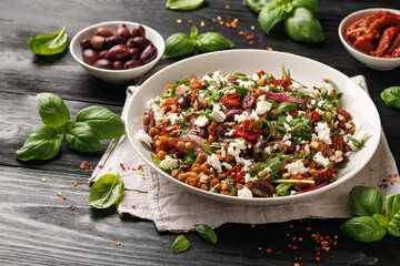 Lentil and Goats Cheese Salad with olives, onion, sun dried tomatoes and arugula. Healthy food