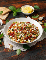 Pearl Couscous salad with sun dried tomatoes, chickpeas and feta cheese. healthy food