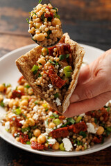 Pearl Couscous salad with sun dried tomatoes, chickpeas and feta cheese. healthy food