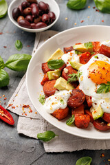 Sweet Potato and Chorizo Hash with egg, avocado and herbs.