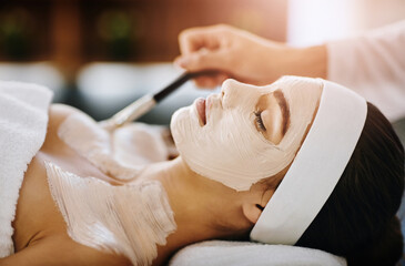 Woman, spa and relaxing with face mask for skincare, pamper weekend and wellness with client. Facialist, treatment and skin rejuvenation or pore tightening, eyes closed and cosmetic beauty facial