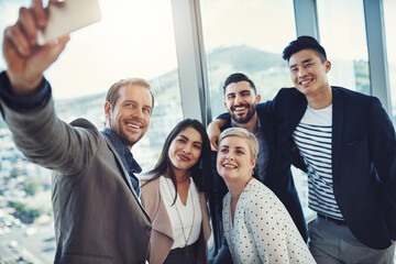Obraz premium Happy, company and business people with selfie in office for team building, networking and unity. Smile, employees and HR with digital photography for recruitment, onboarding and memory of hiring