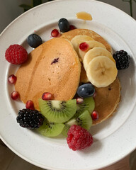 pancakes with berries, banana and kiwi